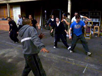 DR. BEAT Bboying / Breakdancing with young people in Wester Hailes on brick paving beside lit street light, fence and house at night